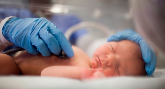 USA, Utah, Payson, Nurse listening to heartbeat of newborn in incubator